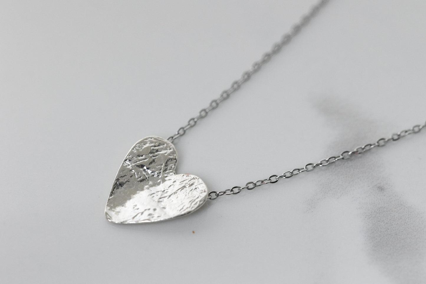 Silver semi-flip heart necklace